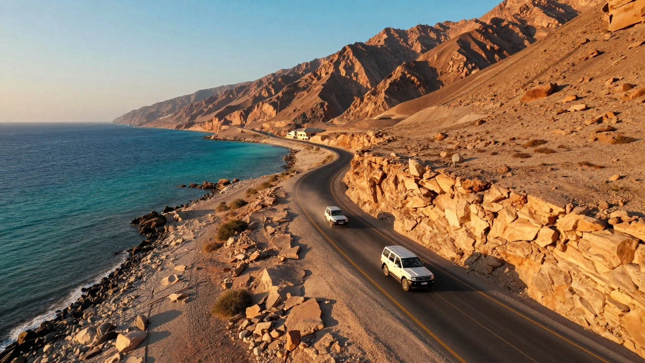SUVs driving on scenic coastal mountain road in UAE