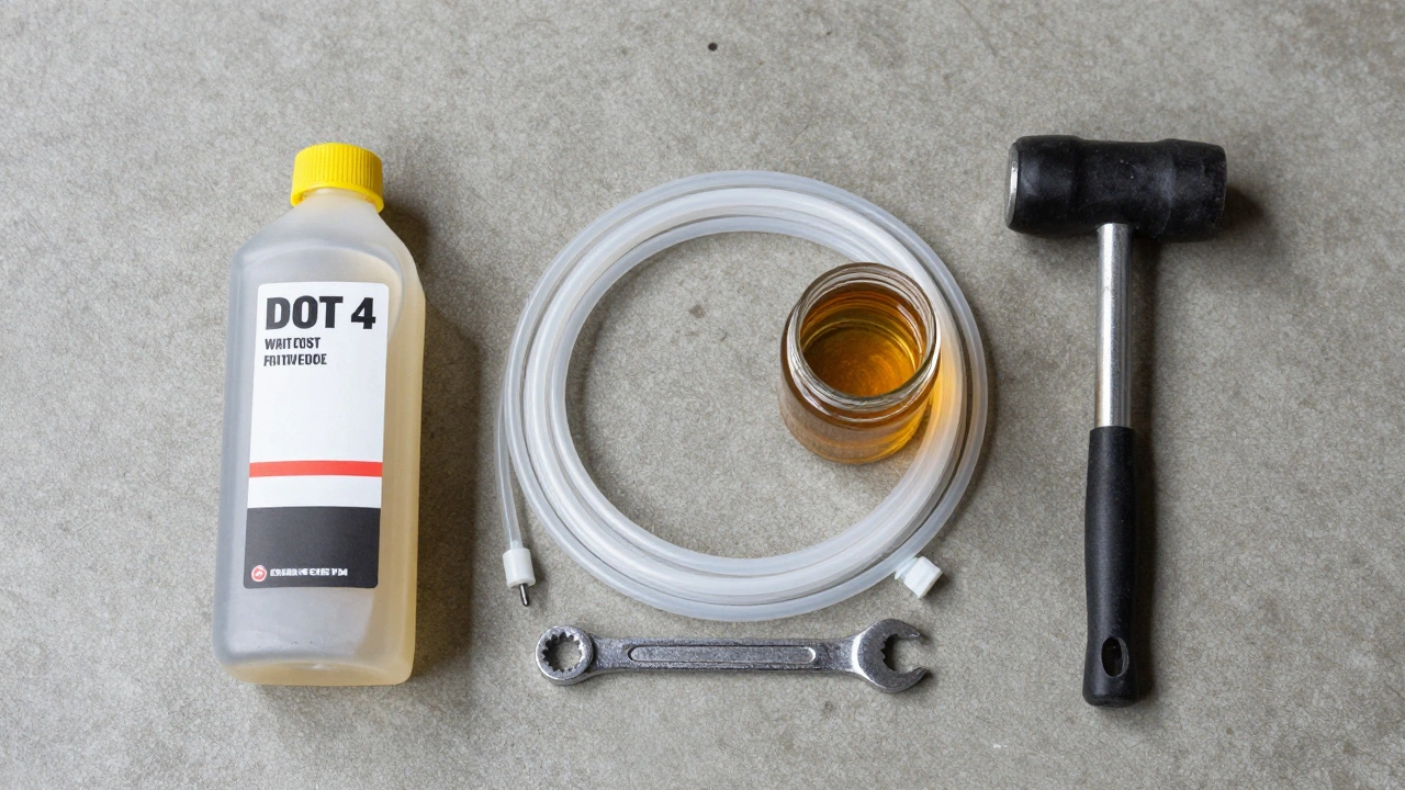 Tools for brake bleeding laid out on a clean garage floor.
